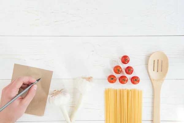 Tomatoes and raw pasta — Stock Photo