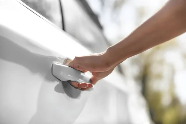 Woman opening car door — Stock Photo