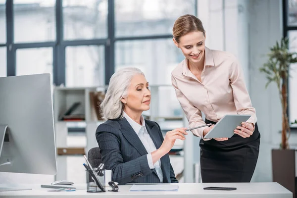 Businesswomen with digital tablet — Stock Photo