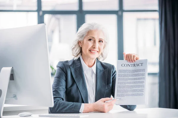 Businesswoman pointing at contract — Stock Photo