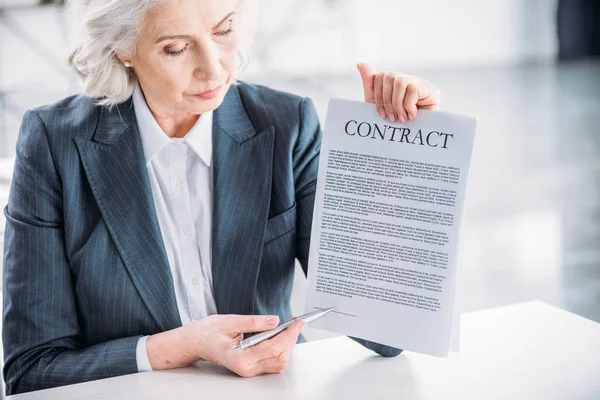 Businesswoman pointing at contract — Stock Photo