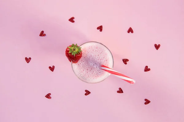 Strawberry milkshake in glass with drinking straw — Stock Photo