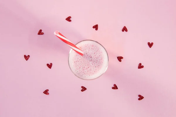 Strawberry milkshake in glass with drinking straw — Stock Photo