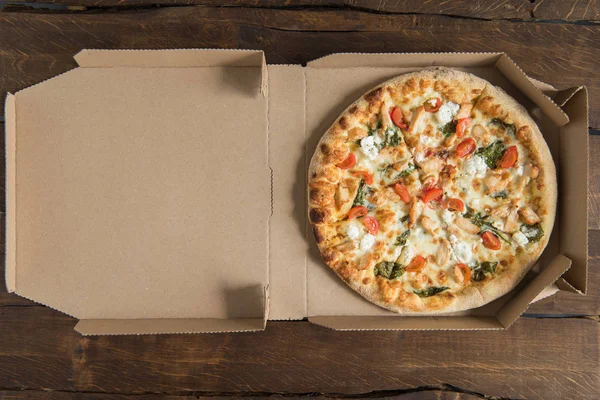 Delicious pizza on table — Stock Photo