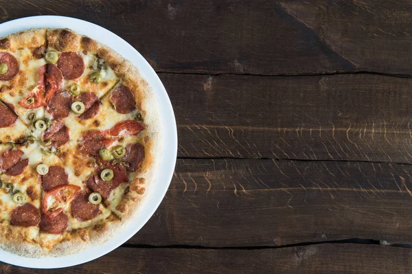 Delicious pizza on table — Stock Photo