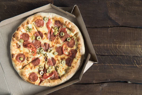 Delicious pizza on table — Stock Photo