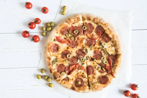 Pizza italiana com ingredientes na mesa — Fotografia de Stock