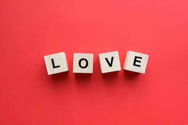 Wooden cubes with love sign — Stock Photo