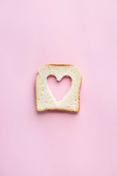 Toasted bread with heart shaped hole — Stock Photo