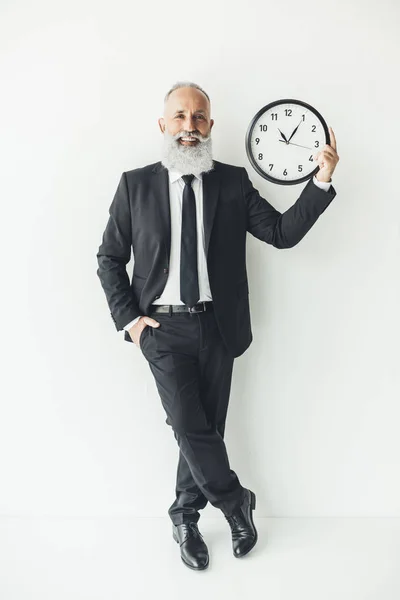 Mature businessman with clock — Stock Photo