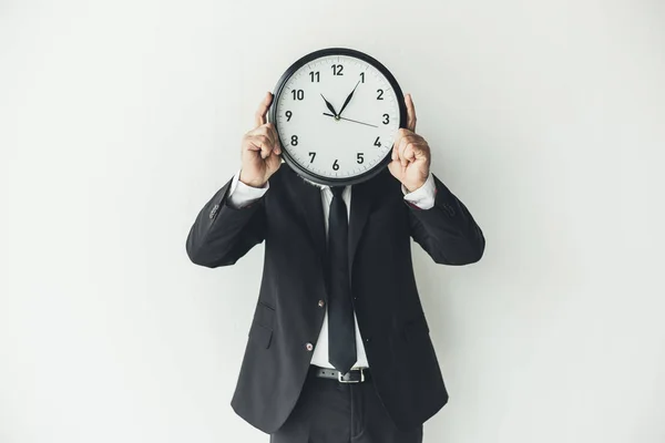 Man covering face with clock — Stock Photo