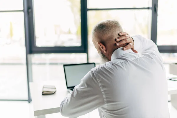 Businessman with pain in neck — Stock Photo