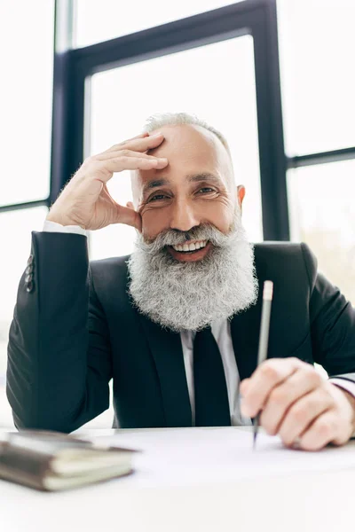 Happy businessman at workplace — Stock Photo