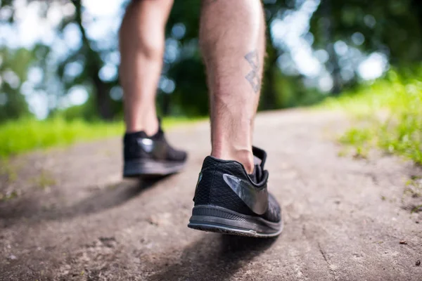 Feet of runner in sports shoes — Stock Photo