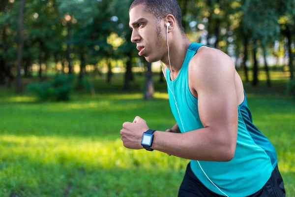 African american sportsman running in park — Stock Photo