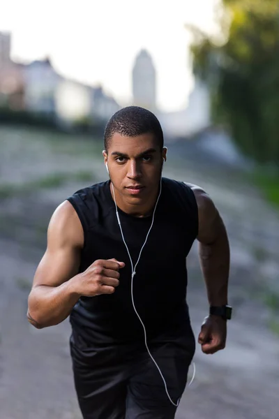 African american sportsman running on street — Stock Photo