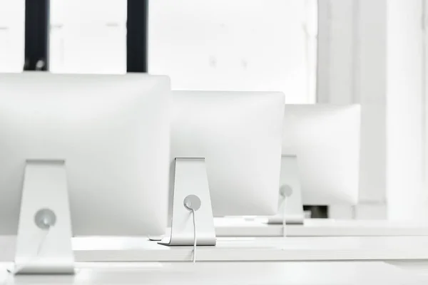 Computer monitors on tables in class — Stock Photo