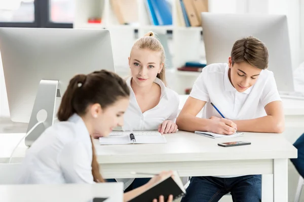 Teenagers during lesson in classroom — Stock Photo