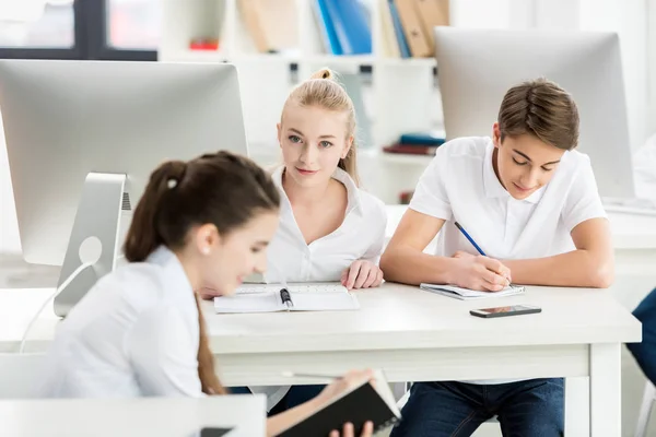 Adolescentes durante la lección en el aula - foto de stock