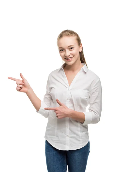 Caucasian teenage girl pointing away — Stock Photo