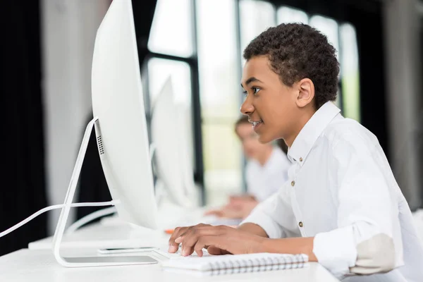 African american teenager working on computer — Stock Photo