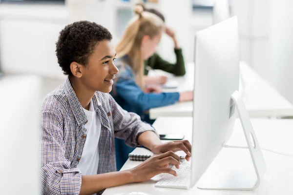 African american teenager working on computer — Stock Photo