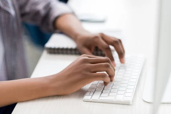 African american teenager working on computer — Stock Photo