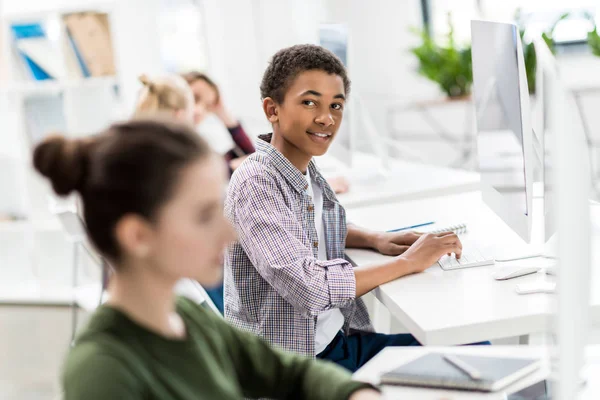 African american teenager studying in class — Stock Photo