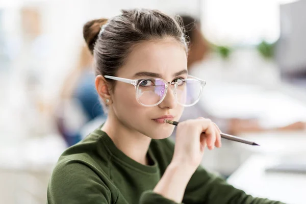 Serious teenage girl with pencil — Stock Photo