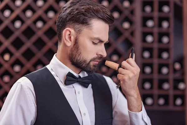 Sommelier examining smell of wine cork — Stock Photo