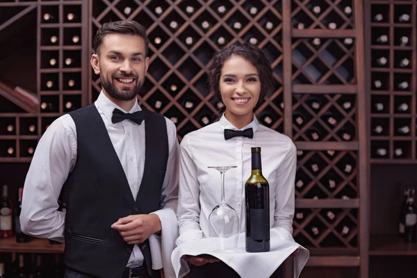 Waiters with wine in cellar — Stock Photo