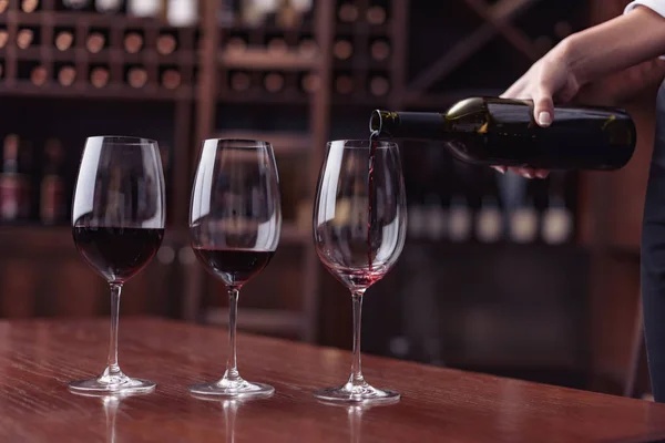 Sommelier pouring red wine — Stock Photo