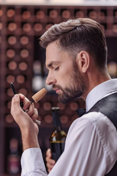 Sommelier examining smell of wine cork — Stock Photo