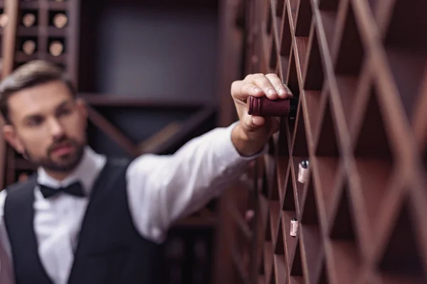 Sommelier in wine cellar — Stock Photo