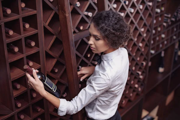 Sommelier in wine cellar — Stock Photo