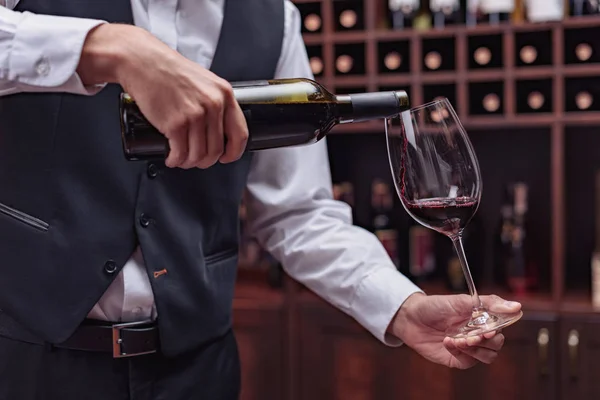 Sommelier pouring red wine — Stock Photo