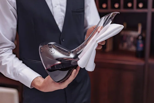 Sommelier with decanter of wine — Stock Photo