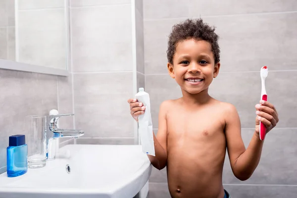 Enfant avec brosse à dents et pâte — Photo de stock