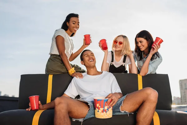 Women flirting with young man on party — Stock Photo