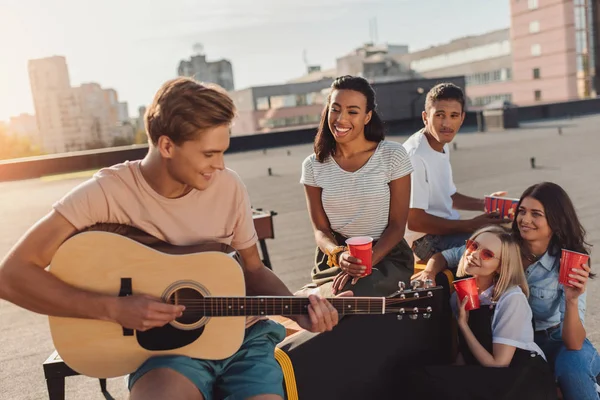 Friends having party on roof — Stock Photo