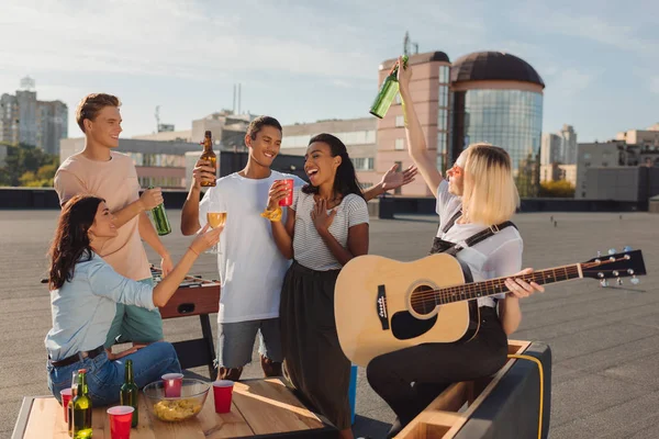 Friends having party on roof — Stock Photo