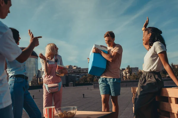 Friends with fridge of beer on roof — Stock Photo