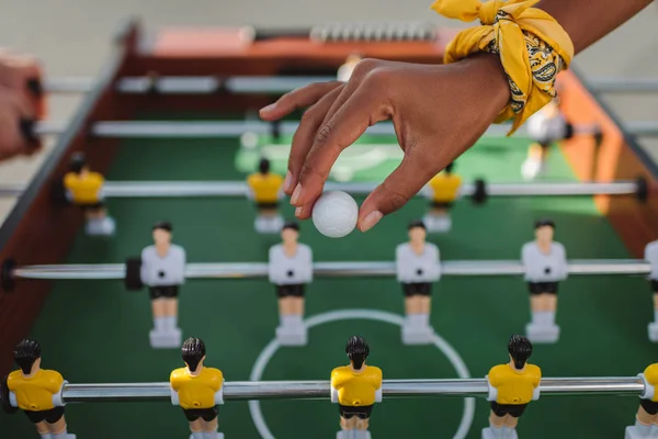 Woman holding ball for table football — Stock Photo