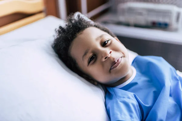 African american boy lying in bed — Stock Photo