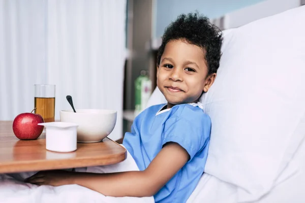 African american boy with breakfast in clinic — Stock Photo