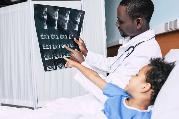 Médico afroamericano y paciente con imagen de rayos X - foto de stock