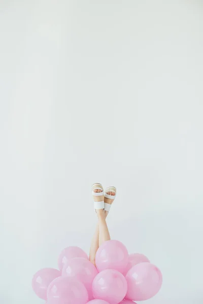 Female legs and balloons — Stock Photo