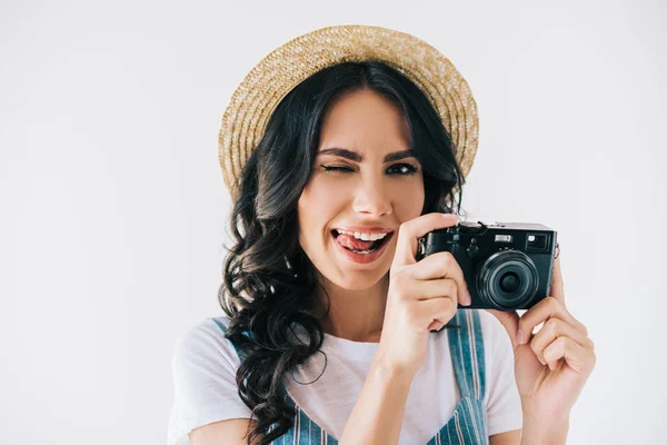 Winking woman with photo camera in hands — Stock Photo