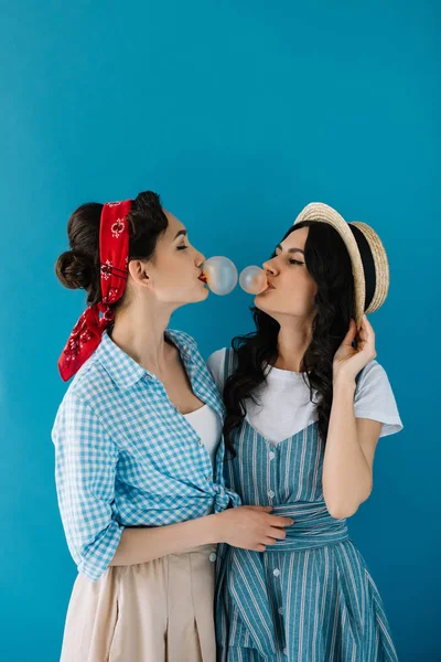 Multicultural women blowing bubble gum — Stock Photo