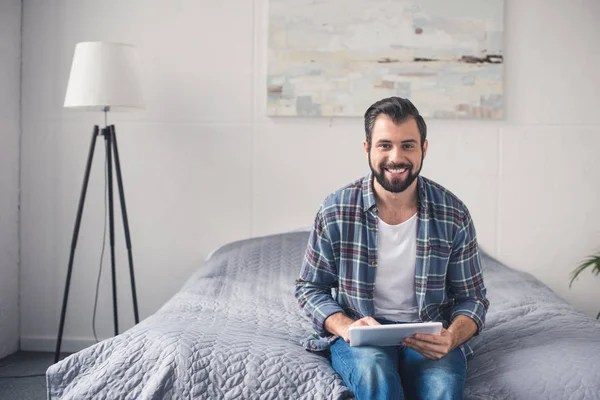 Man with tablet at home — Stock Photo